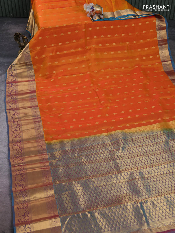 Kanchipuram silk saree sunset orange and dual shade of pinkish teal blue with allover zari woven buttas and long rich zari woven border