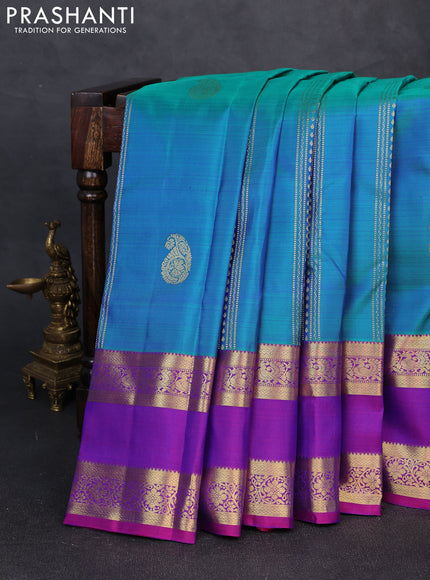 Pure kanchipuram silk saree dual shade of bluish green and purple with zari woven buttas and rettapet zari woven border