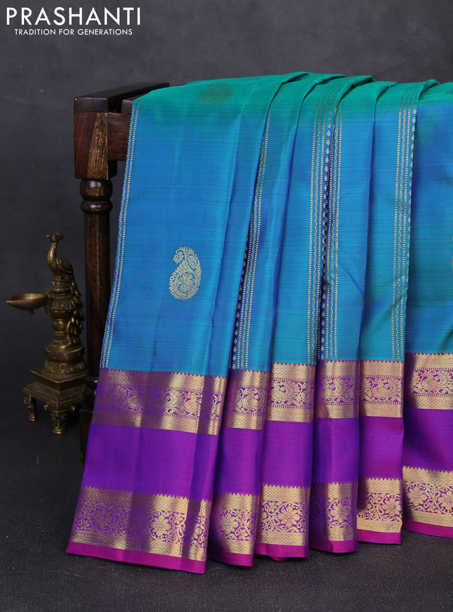 Pure kanchipuram silk saree dual shade of bluish green and purple with zari woven buttas and rettapet zari woven border