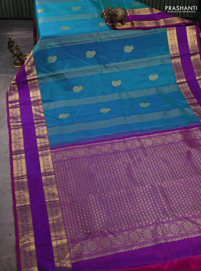 Pure kanchipuram silk saree dual shade of bluish green and purple with zari woven buttas and rettapet zari woven border