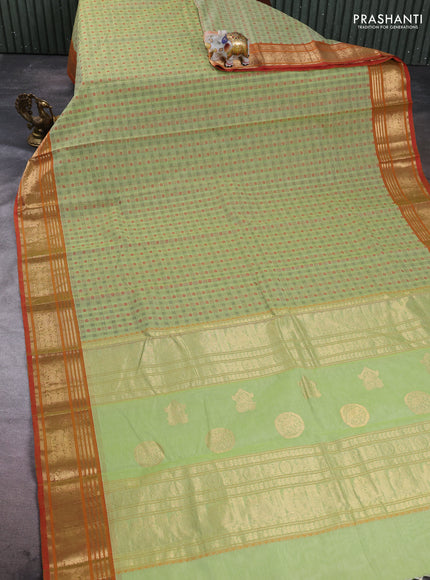 Kanchi cotton saree pista green and orange with allover zari woven checked pattern and zari woven border