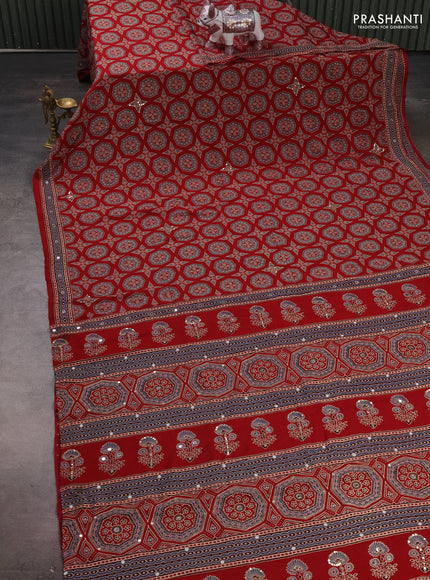 Muslin silk saree red shade with allover ajrakh butta prints and sequin mirror work embroidery pallu