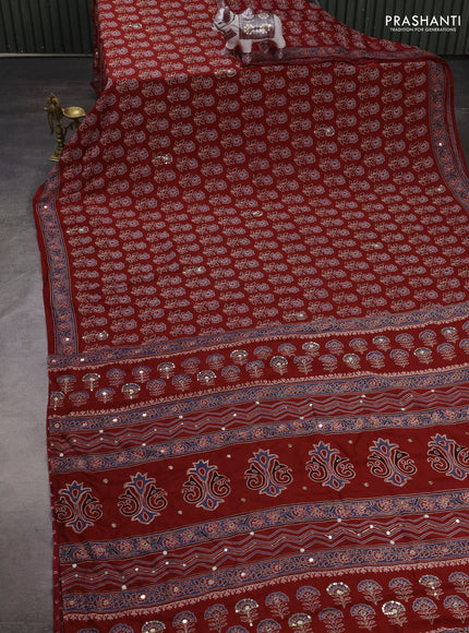Muslin silk saree red shade with allover ajrakh butta prints and sequin mirror work embroidery pallu