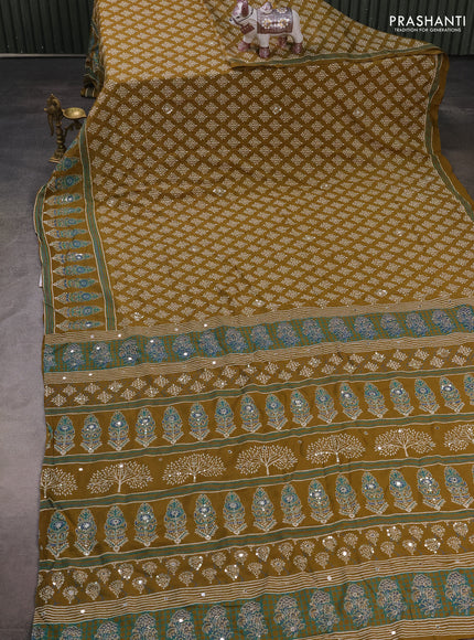 Muslin silk saree mehendi green with allover dabu butta prints and sequin mirror work embroidery pallu