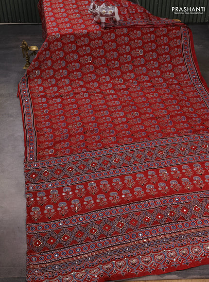 Muslin silk saree red shade with allover ajrakh butta prints and sequin mirror work embroidery pallu