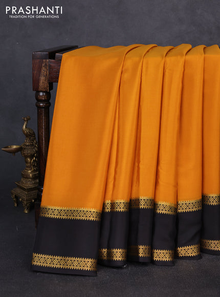 Pure mysore silk mustard yellow and black with plain body and rettapet zari woven border