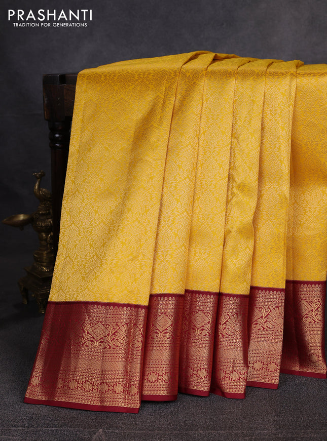 Pure kanchipuram silk saree yellow and maroon with allover zari woven brocade weaves and zari woven korvai border