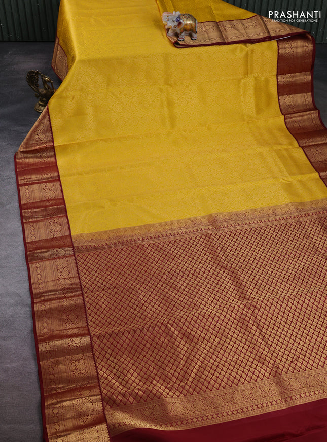 Pure kanchipuram silk saree yellow and maroon with allover zari woven brocade weaves and zari woven korvai border