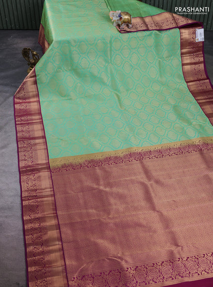 Pure kanchipuram silk saree teal green and purple with allover zari woven brocade weaves and rich zari woven border