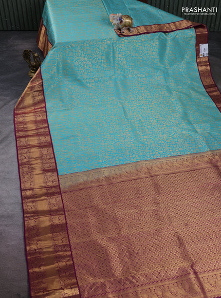 Pure kanchipuram silk saree teal blue and purple with allover zari woven brocade weaves and rich zari woven korvai border