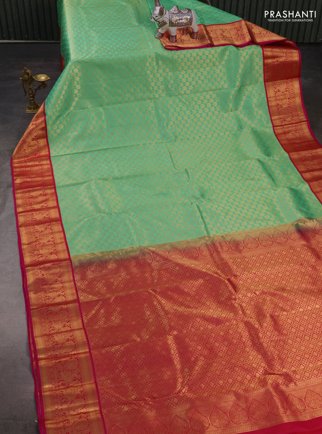 Pure kanchipuram silk saree teal green and pink with allover zari woven brocade pattern and zari woven korvai border