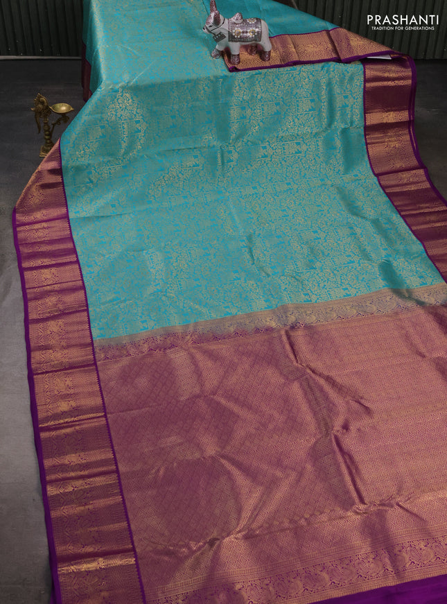 Pure kanchipuram silk saree teal blue and purple with allover zari woven brocade weaves and zari woven korvai border