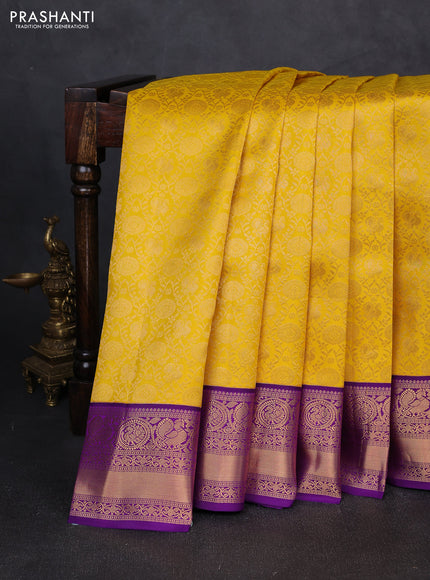 Pure kanchipuram silk saree yellow and purple with allover zari woven brocade weaves and rich zari woven border