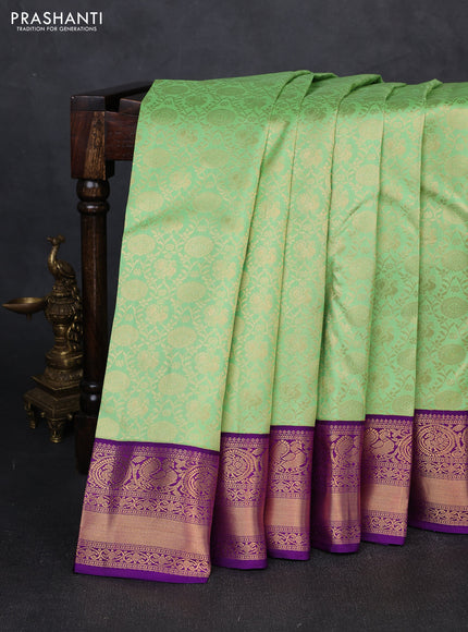 Pure kanchipuram silk saree light green and purple with allover zari woven brocade weaves and rich zari woven korvai border