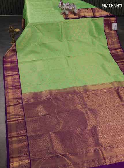 Pure kanchipuram silk saree light green and purple with allover zari woven brocade weaves and rich zari woven korvai border