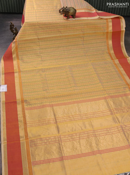 Kanchipuram silk cotton saree pale yellow and dual shade of orange with allover thread checks & 1000 buttas and rettapet zari woven border