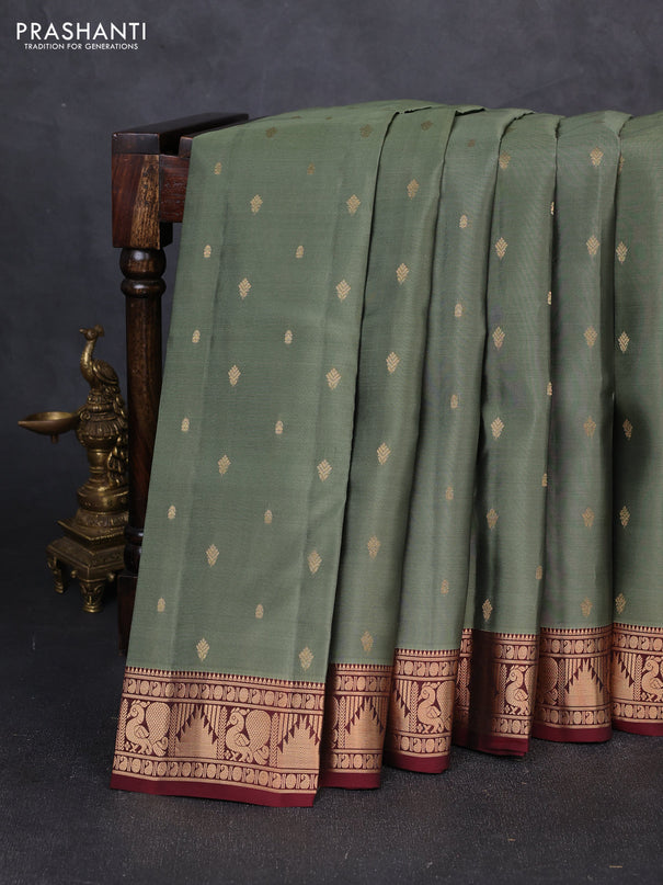 Kanchipuram silk saree pastel green shade and deep maroon with allover zari woven 1000 buttas and annam & temple zari woven border