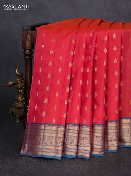 Kanchipuram silk saree dual shade of pinkish orange and dual shade of teal green with allover zari woven 1000 buttas and zari woven border