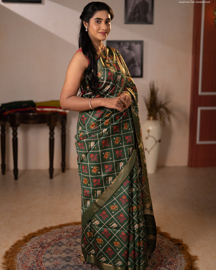 Munga tussar silk saree green with allover patola prints and zari woven border