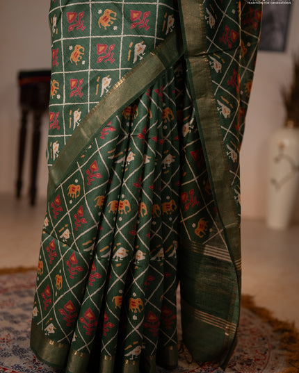 Munga tussar silk saree green with allover patola prints and zari woven border