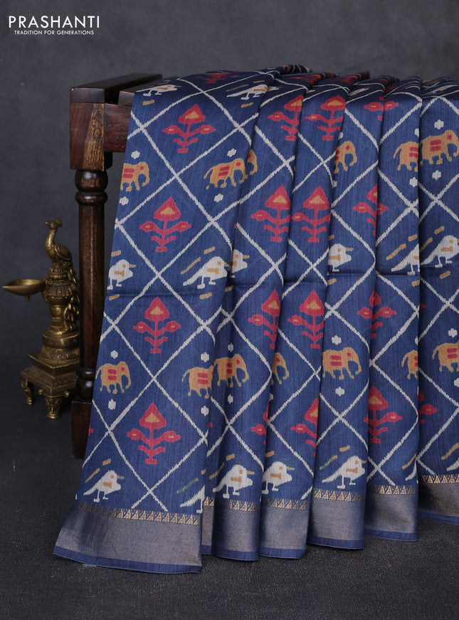 Munga tussar silk saree peacock blue with allover patola prints and zari woven border