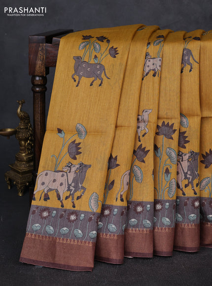Munga tussar silk saree mustard yellow and coffee brown with allover pichwai prints and zari woven border