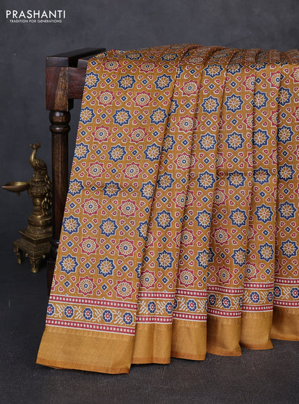 Munga tussar silk saree dark mustard with allover ajrakh prints and zari woven border