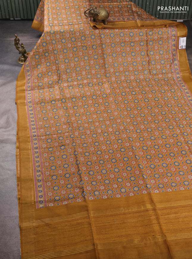 Munga tussar silk saree dark mustard with allover ajrakh prints and zari woven border