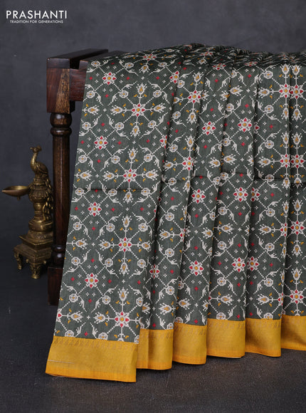 Munga tussar silk saree deep sap green and mustard yellow with allover ikat prints and zari woven border