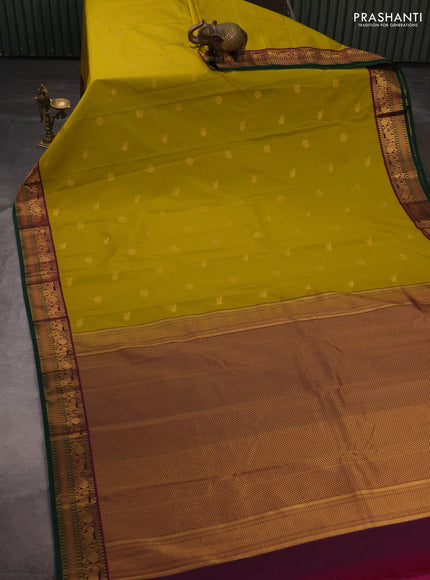 Semi kanchipuram silk saree mustard green and purple with zari woven buttas and temple design zari woven border