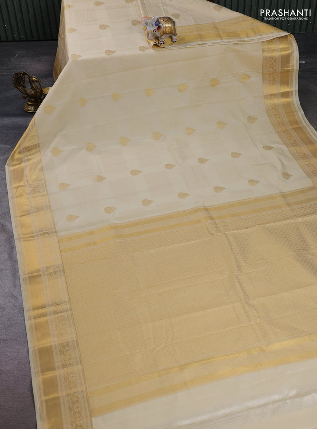 Semi kanchipuram silk saree beige with allover zari weaves & buttas and zari woven border