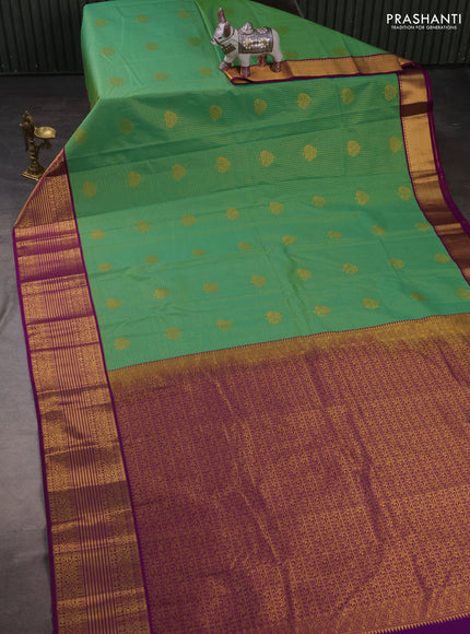 Semi kanchipuram silk saree light green and purple with allover small zari checks & buttas and zari woven border