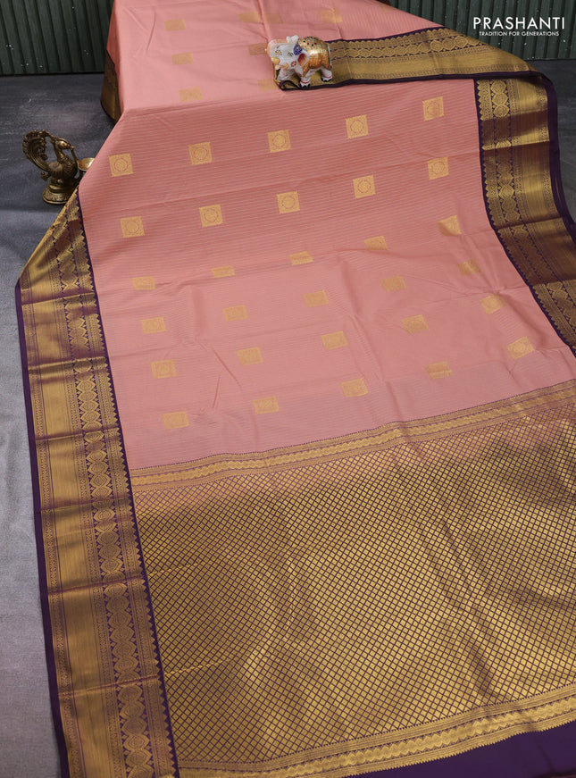 Semi kanchipuram silk saree peach pink and deep purple with allover zari weaves & buttas and temple design zari woven border