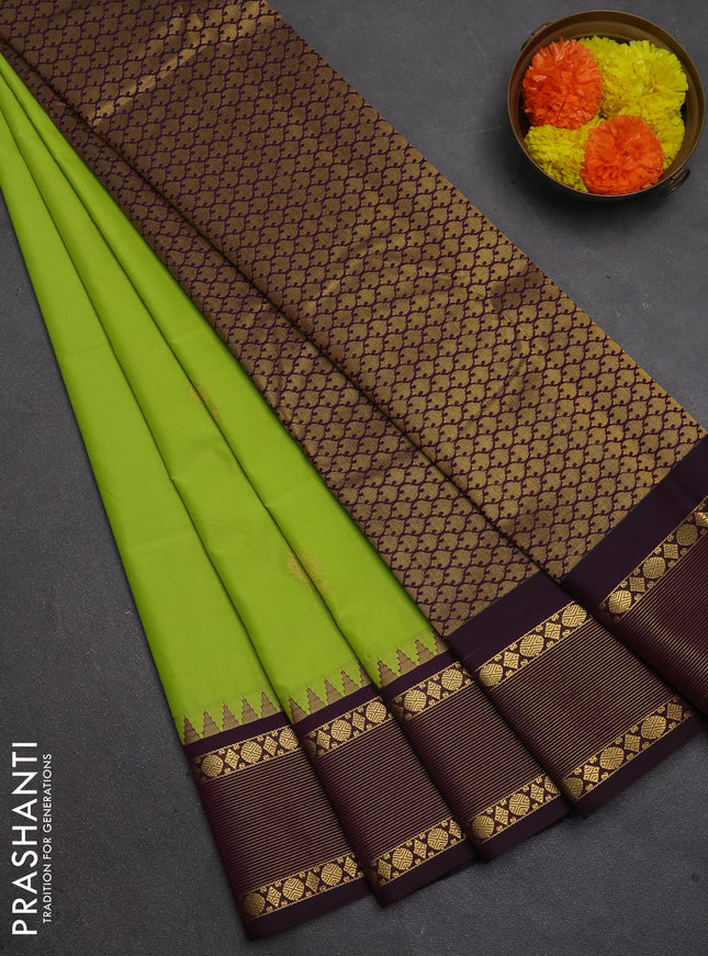 Semi kanchipuram silk saree light green and deep purple with zari woven buttas and temple design zari woven korvai border