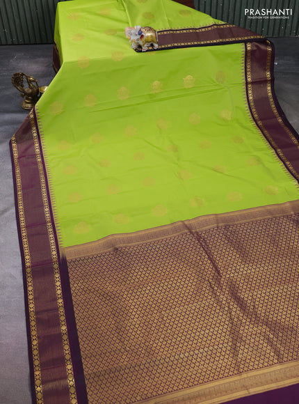 Semi kanchipuram silk saree light green and deep purple with zari woven buttas and temple design zari woven korvai border