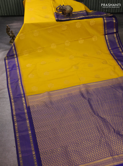 Semi kanchipuram silk saree mustard yellow and blue with zari woven buttas and temple design zari woven border