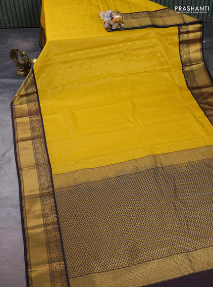 Semi kanchipuram silk saree mustard yellow and coffee brown with allover zari checks & buttas and temple design rich zari woven border