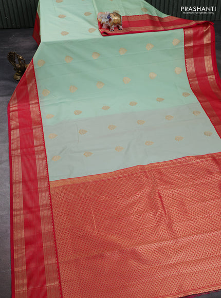 Semi kanchipuram silk saree mild teal green and pink with zari woven buttas and temple desgin zari woven korvai border