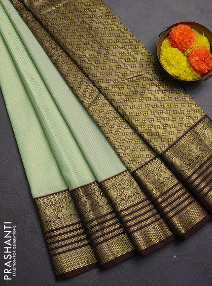 Semi kanchipuram silk saree mild pista green and coffee brown with allover small zari checks & buttas and temple desgin zari woven border