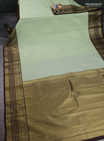 Semi kanchipuram silk saree mild pista green and coffee brown with allover small zari checks & buttas and temple desgin zari woven border