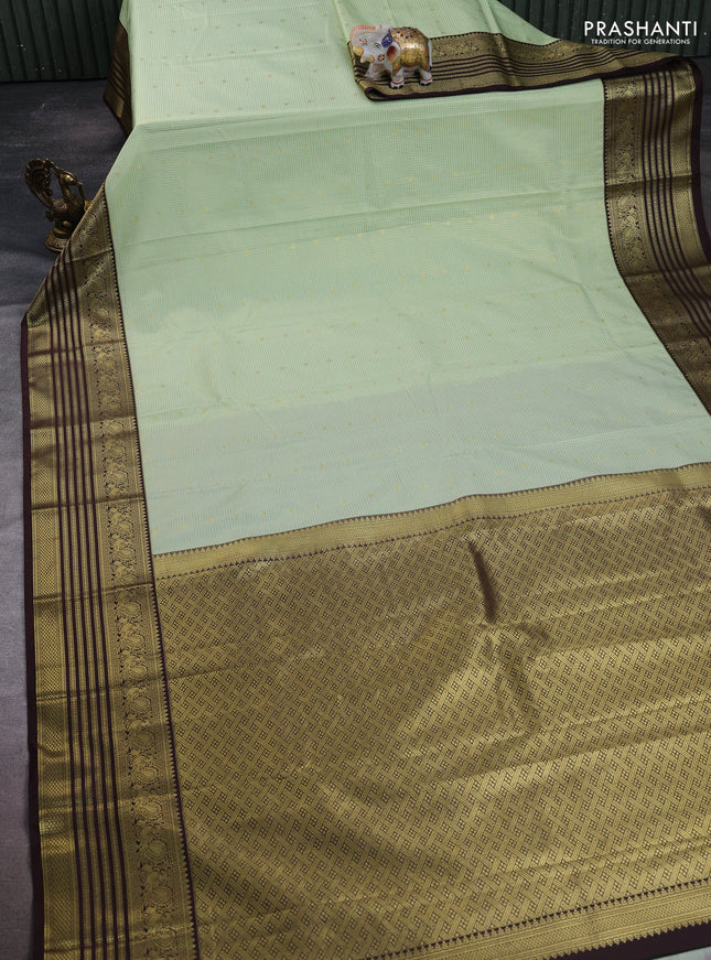 Semi kanchipuram silk saree mild pista green and coffee brown with allover small zari checks & buttas and temple desgin zari woven border