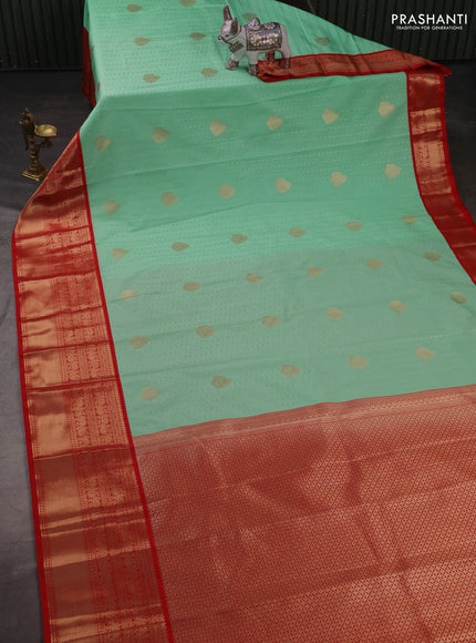 Semi kanchipuram silk saree mild teal green and red with allover zari woven 1000 buttas and long rich zari woven korvai border