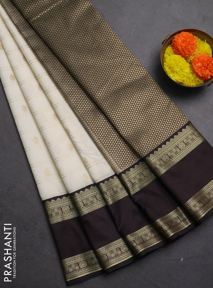 Semi kanchipuram silk saree off white and black with allover zari weaves & buttas and rettapet zari woven korvai border