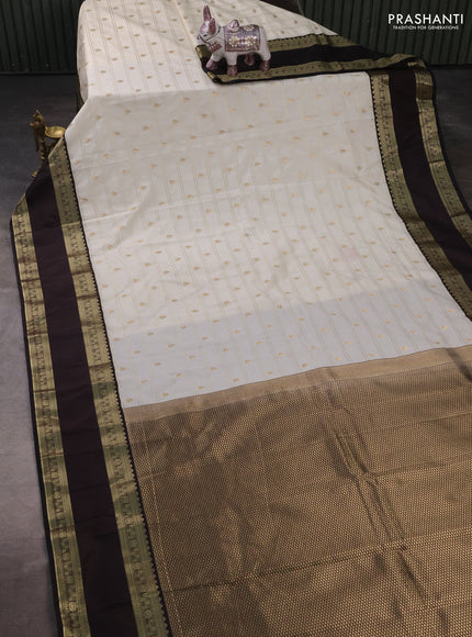 Semi kanchipuram silk saree off white and black with allover zari weaves & buttas and rettapet zari woven korvai border