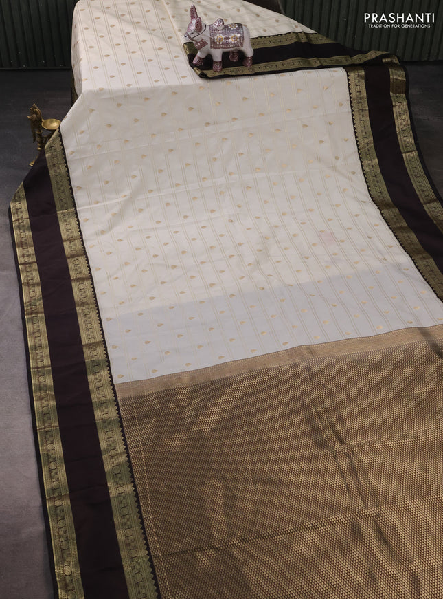 Semi kanchipuram silk saree off white and black with allover zari weaves & buttas and rettapet zari woven korvai border