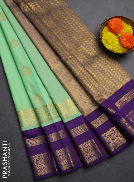 Semi kanchipuram silk saree mild teal green and purple with allover zari woven buttas and long zari woven korvai border