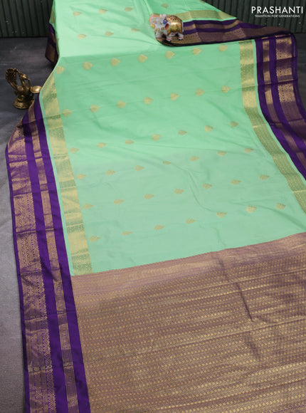 Semi kanchipuram silk saree mild teal green and purple with allover zari woven buttas and long zari woven korvai border
