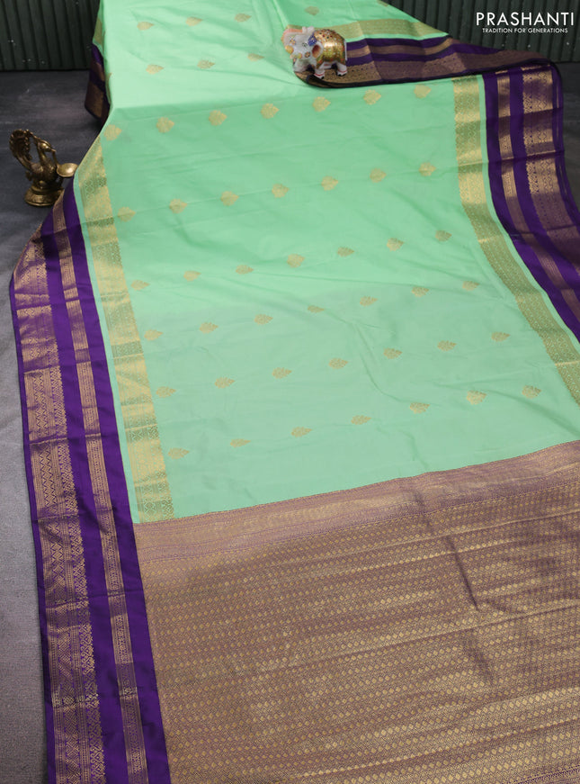 Semi kanchipuram silk saree mild teal green and purple with allover zari woven buttas and long zari woven korvai border