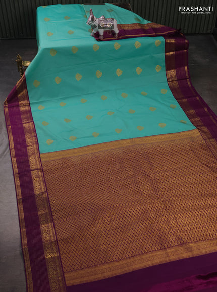 Semi kanchipuram silk saree teal green and purple with zari woven buttas and zari woven korvai border