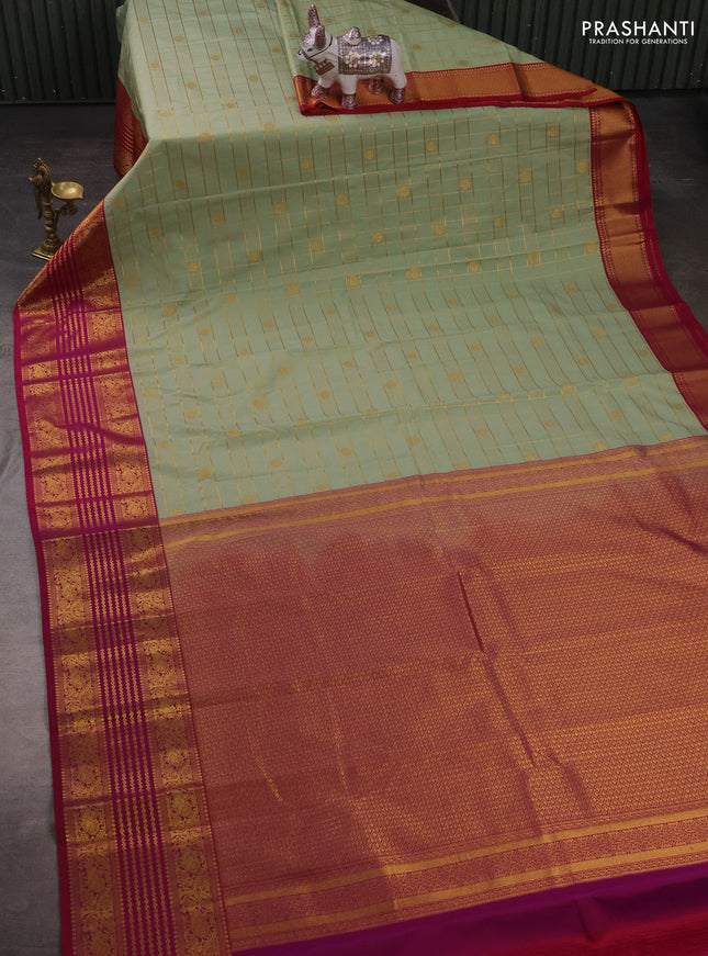 Semi kanchipuram silk saree pastel green and magenta pink with allover zari checks & buttas and long zari woven korvai border